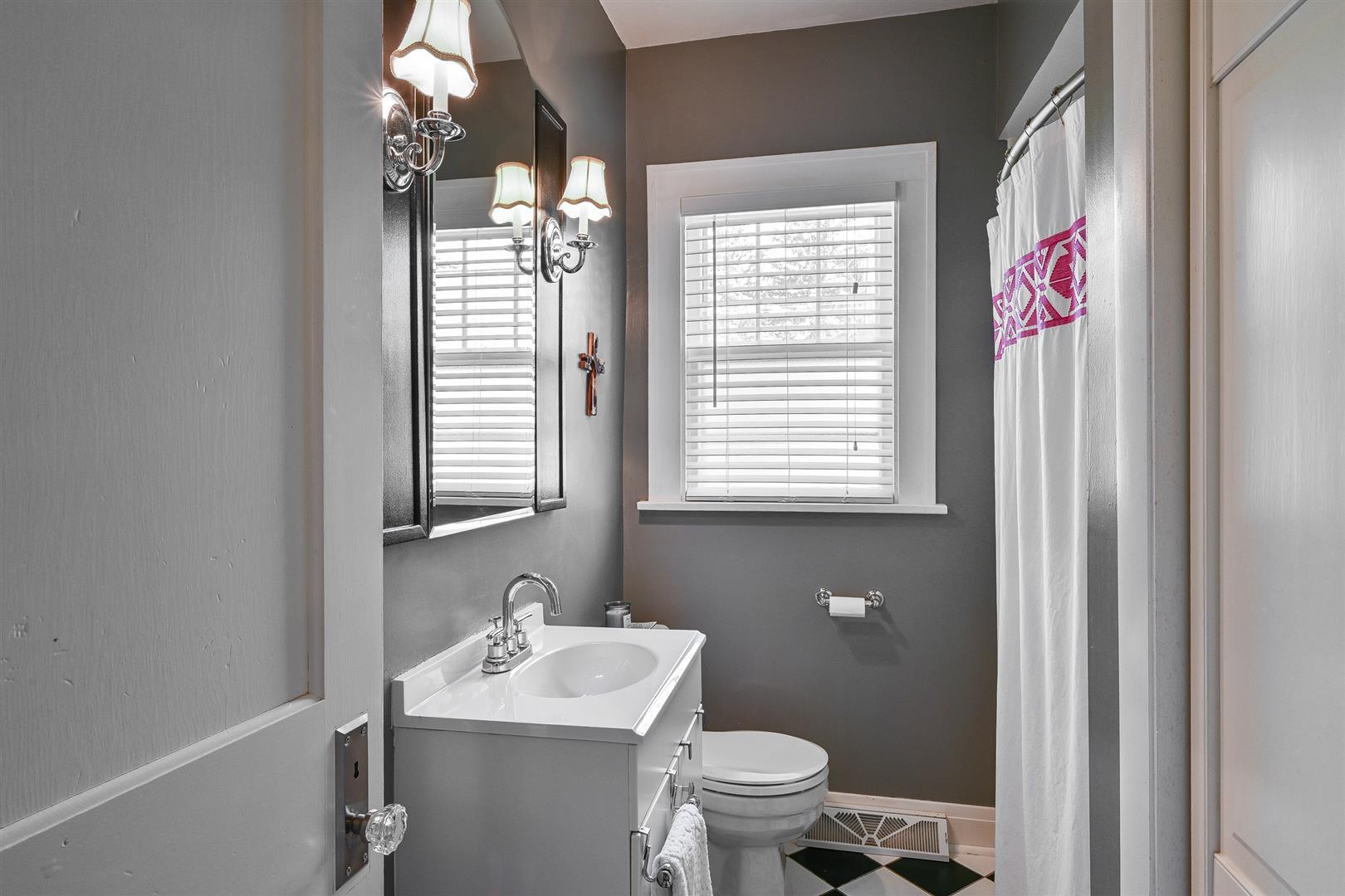 804 Warrenville Road Wheaton, IL 60189 - Photo 14 of 30 a bathroom with a sink a toilet and a window