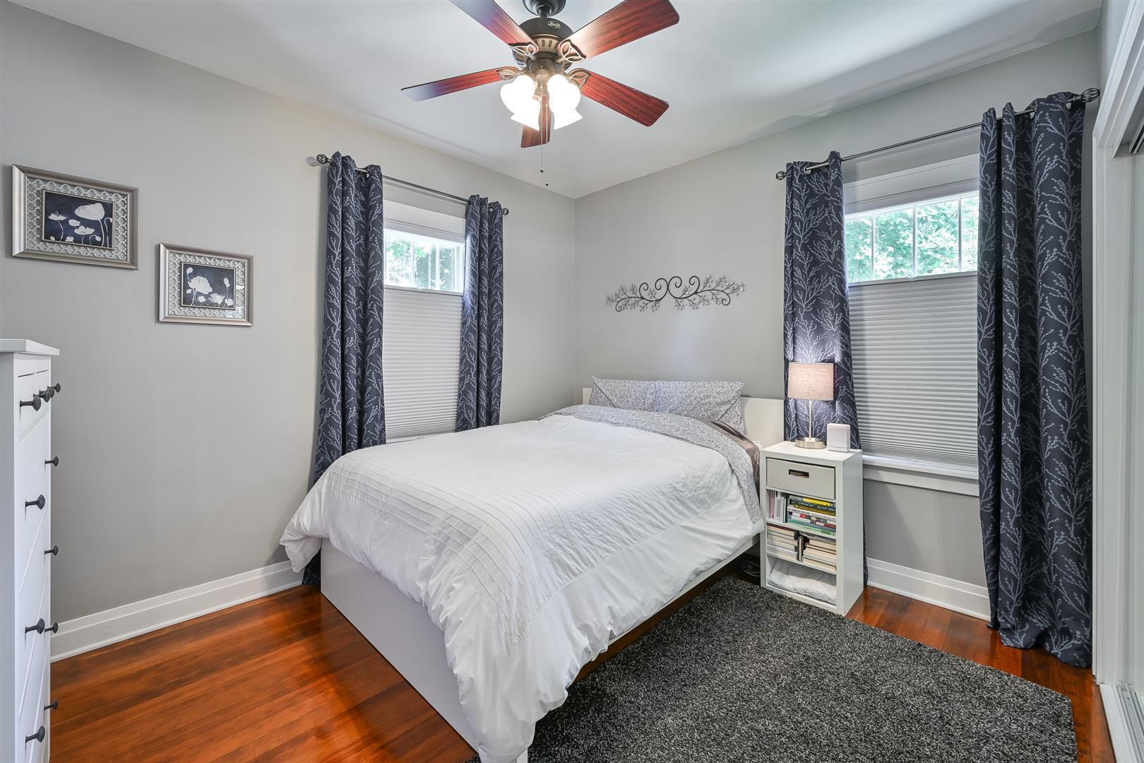 804 Warrenville Road Wheaton, IL 60189 - Photo 15 of 30 a bedroom with a bed and a chandelier