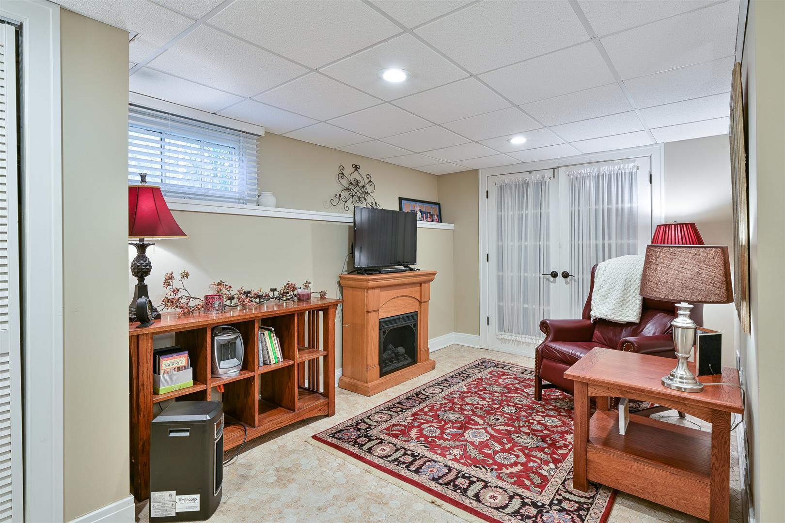 804 Warrenville Road Wheaton, IL 60189 - Photo 18 of 30 a living room with furniture and a flat screen tv