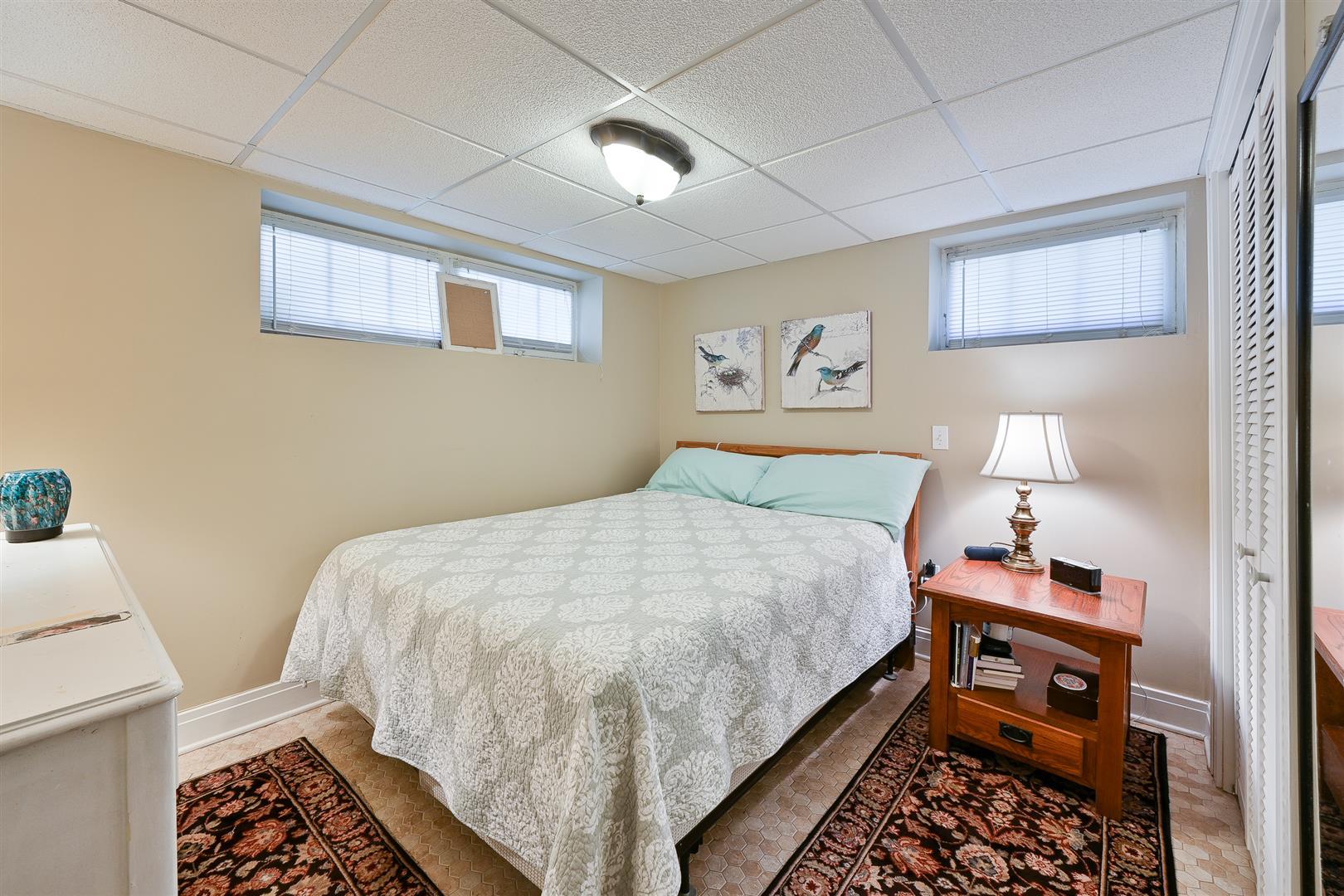 804 Warrenville Road Wheaton, IL 60189 - Photo 23 of 30 a bedroom with a bed and wooden floor