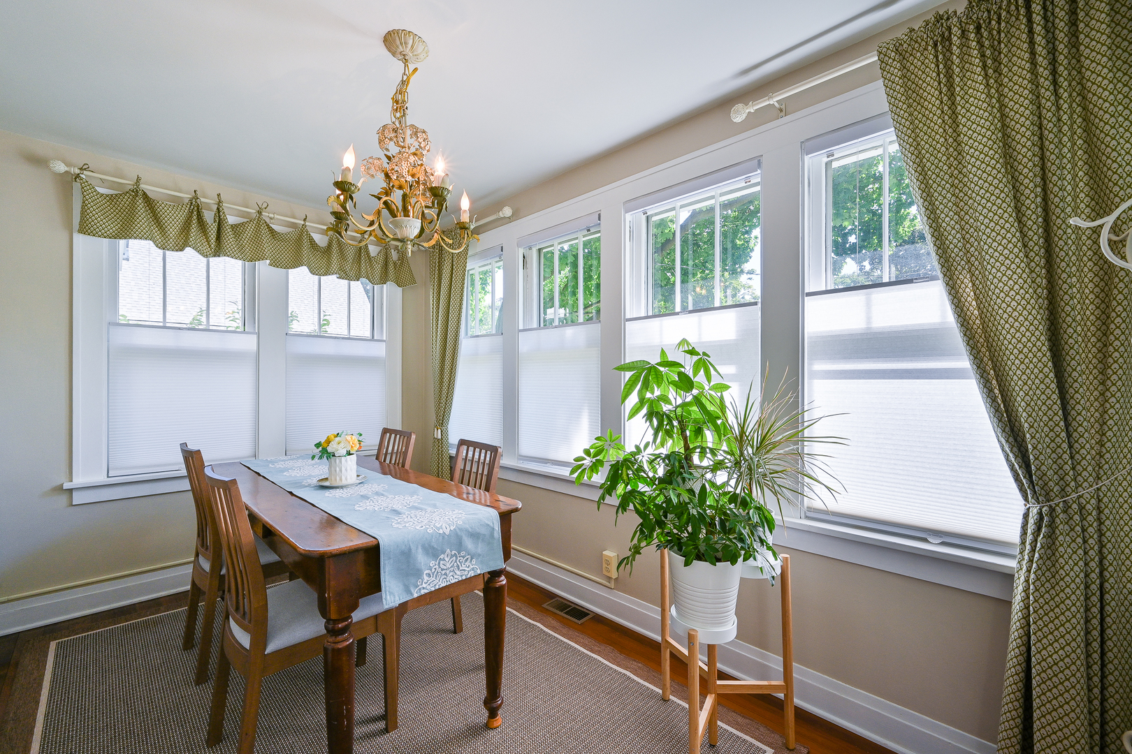 804 Warrenville Road Wheaton, IL 60189 - Photo 5 of 30 a dining room with furniture potted plants and wooden floor