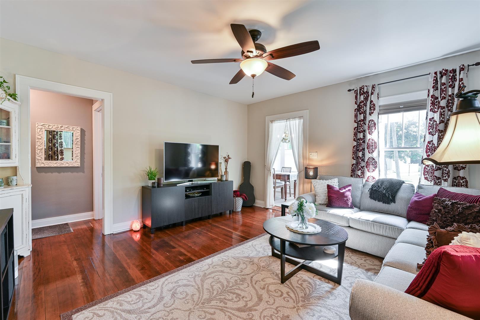 804 Warrenville Road Wheaton, IL 60189 - Photo 8 of 30 a living room with furniture wooden floor and a flat screen tv