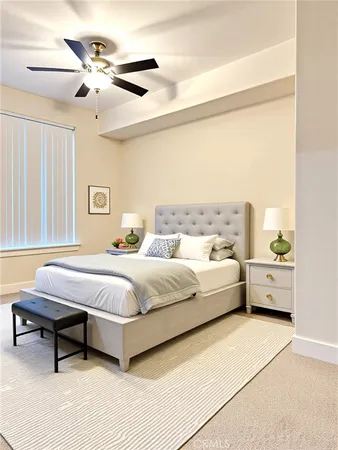 a spacious bedroom with a bed and a chandelier