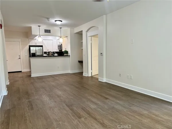 a view of a kitchen with kitchen island and stainless steel appliances