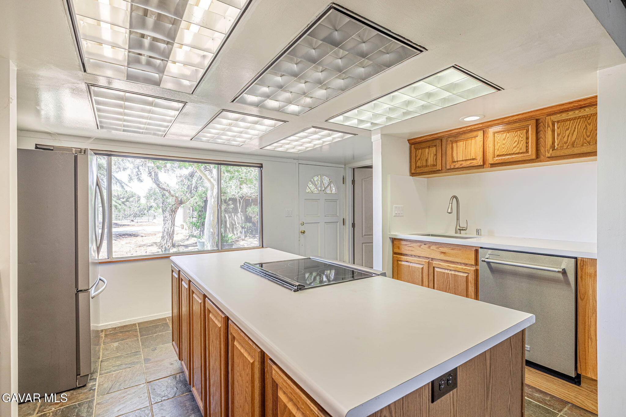 4819 Columbia Way Lancaster, CA 93536 - Photo 14 of 33 a kitchen that has a sink a stove and a refrigerator
