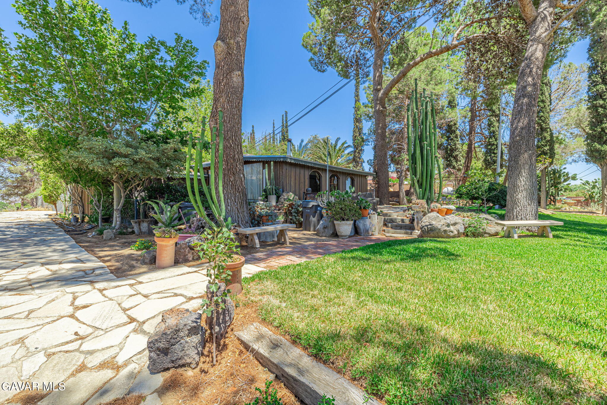 4819 Columbia Way Lancaster, CA 93536 - Photo 2 of 33 a view of a patio with couches table and chairs with plants and trees