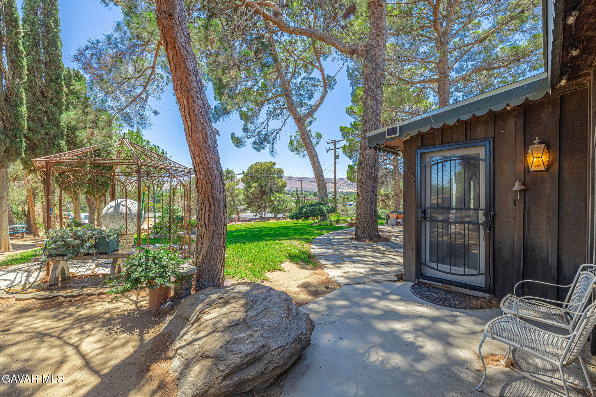 4819 Columbia Way Lancaster, CA 93536 - Photo 4 of 33 a view of a chair and table in backyard of the house