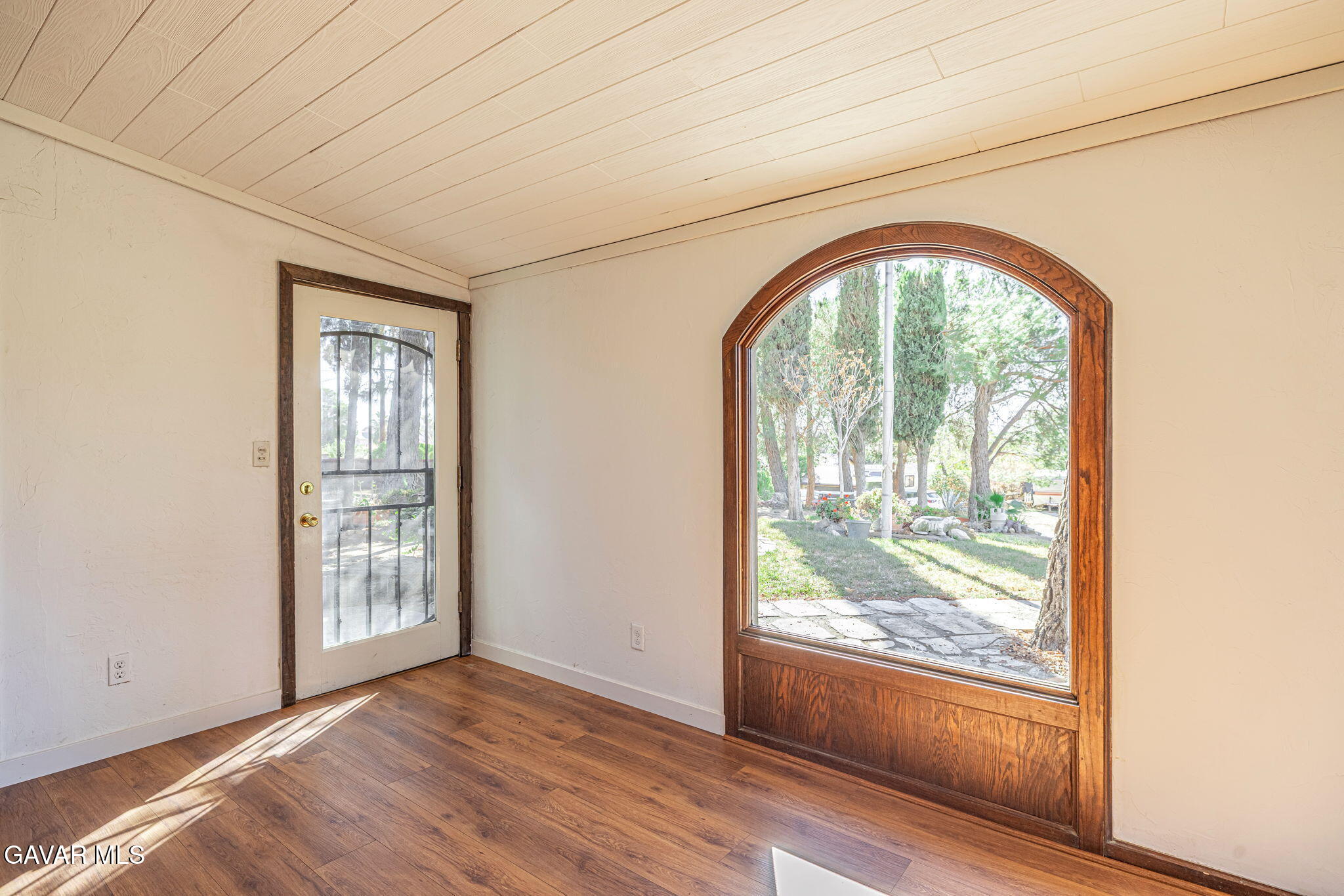 4819 Columbia Way Lancaster, CA 93536 - Photo 5 of 33 an empty room with wooden floor and windows