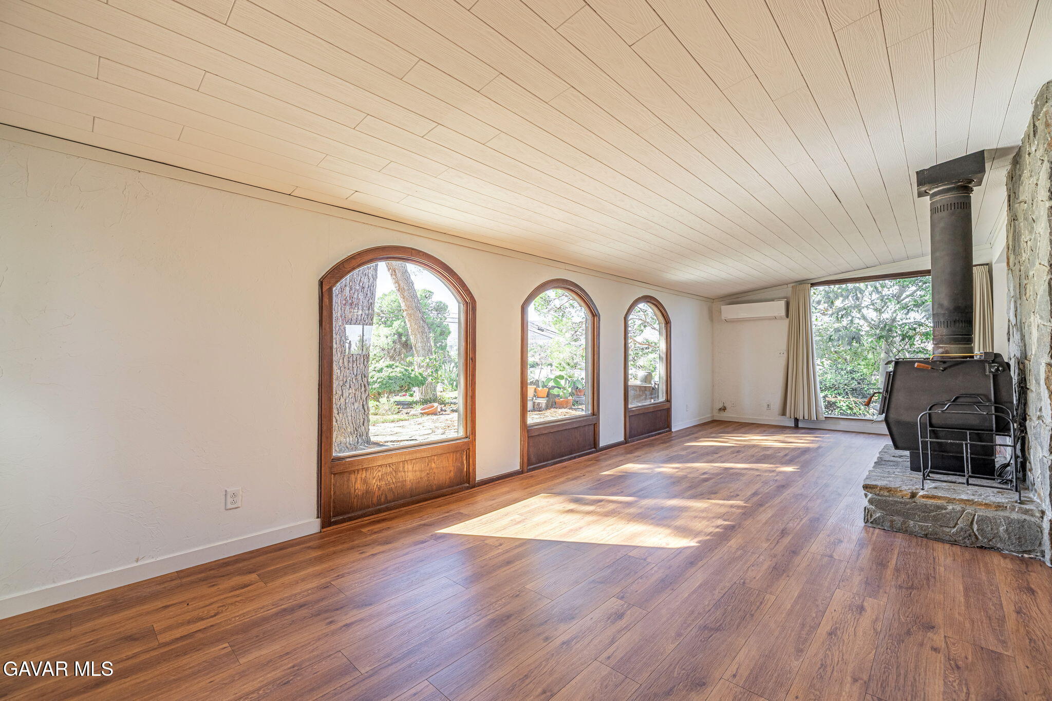 4819 Columbia Way Lancaster, CA 93536 - Photo 6 of 33 a view of an empty room with a window and wooden floor