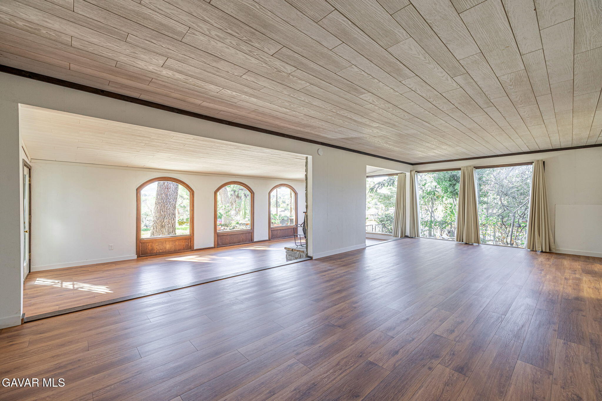 4819 Columbia Way Lancaster, CA 93536 - Photo 10 of 33 a view of an empty room with wooden floor and a window