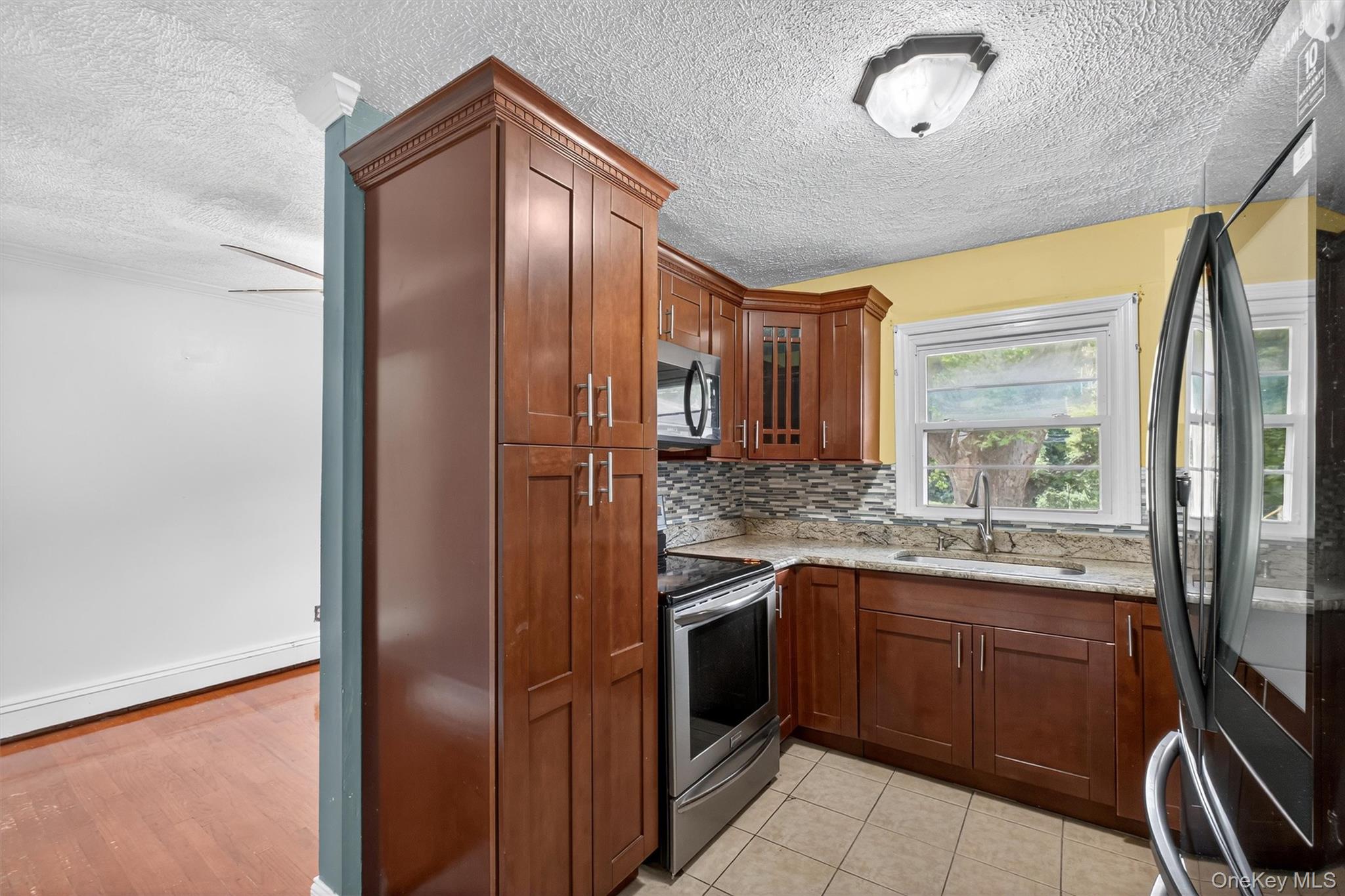 2710 South Road, Unit A4 Poughkeepsie, NY 12601 - Photo 11 of 17 a kitchen with stainless steel appliances granite countertop a refrigerator and a sink