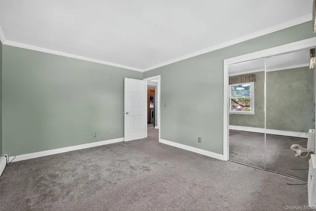 a view of a room with rack on the wall and a window