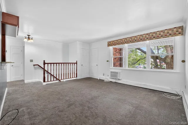 an empty room with wooden floor and closet