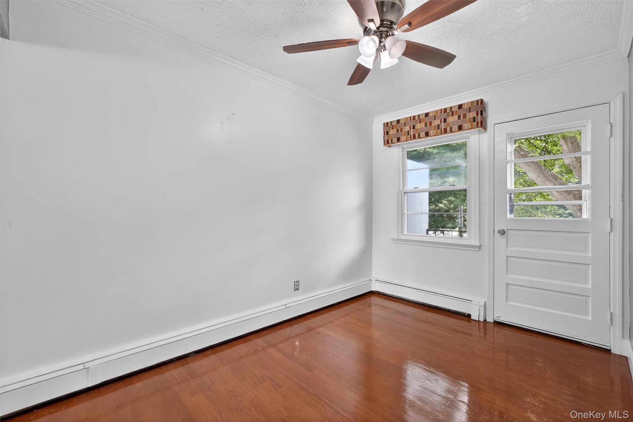 2710 South Road, Unit A4 Poughkeepsie, NY 12601 - Photo 9 of 17 an empty room with windows and fan