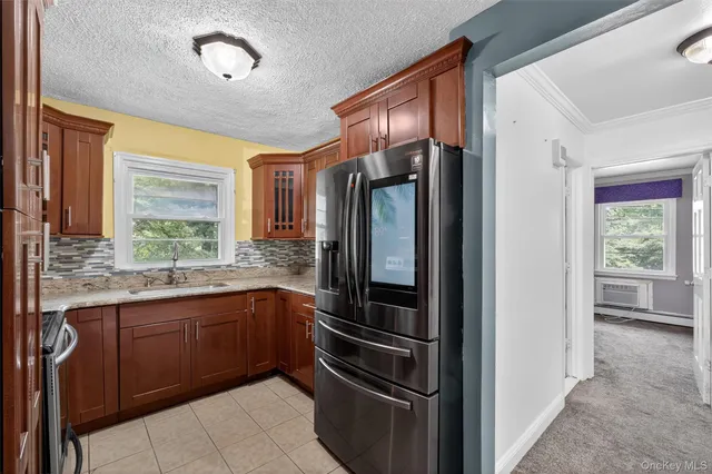 a kitchen with stainless steel appliances granite countertop a refrigerator and a sink
