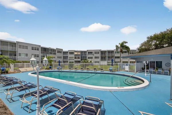 a view of a swimming pool with a table and chairs