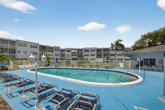 a view of a swimming pool with a table and chairs