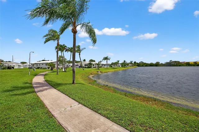 a view of a street with a building and a big yard
