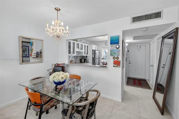 a view of a dining room with furniture and chandelier
