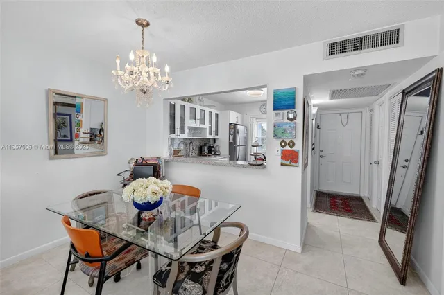 a view of a dining room with furniture and chandelier