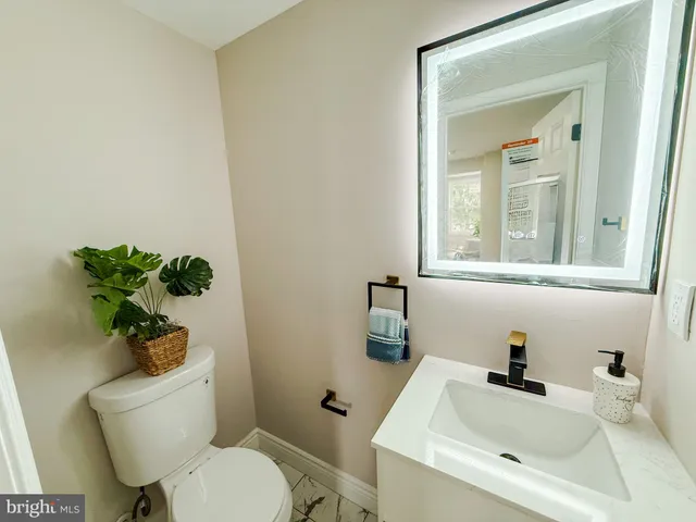 a white toilet sitting next to a bathroom sink