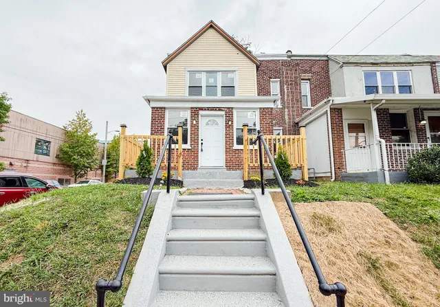 a front view of a house with a yard and plants