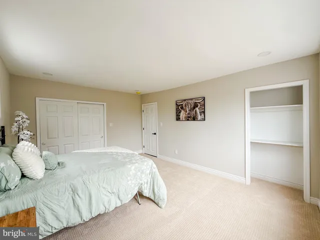 a bedroom with a bed and a painting on the wall