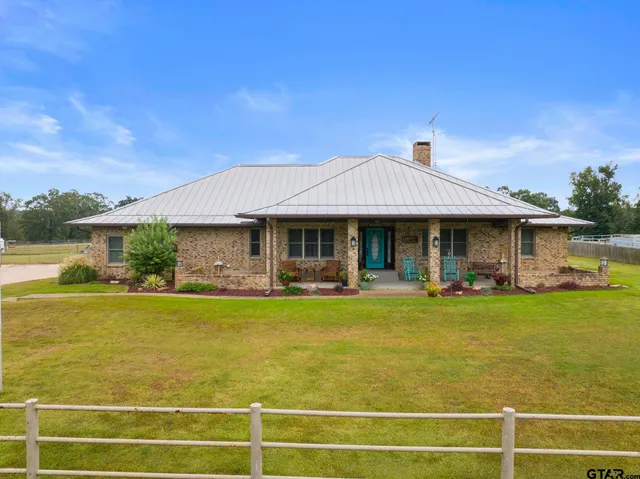 a front view of a house with swimming pool having outdoor seating