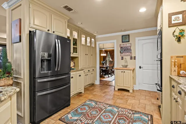 a kitchen with stainless steel appliances a refrigerator and cabinets