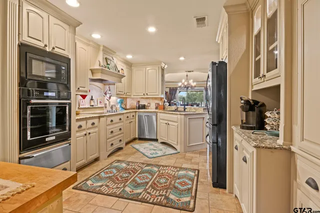 a kitchen with a sink stainless steel appliances and cabinets