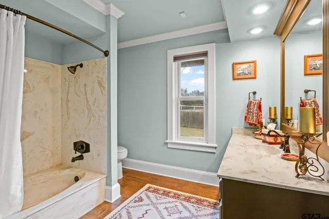 a bathroom with a tub and a window