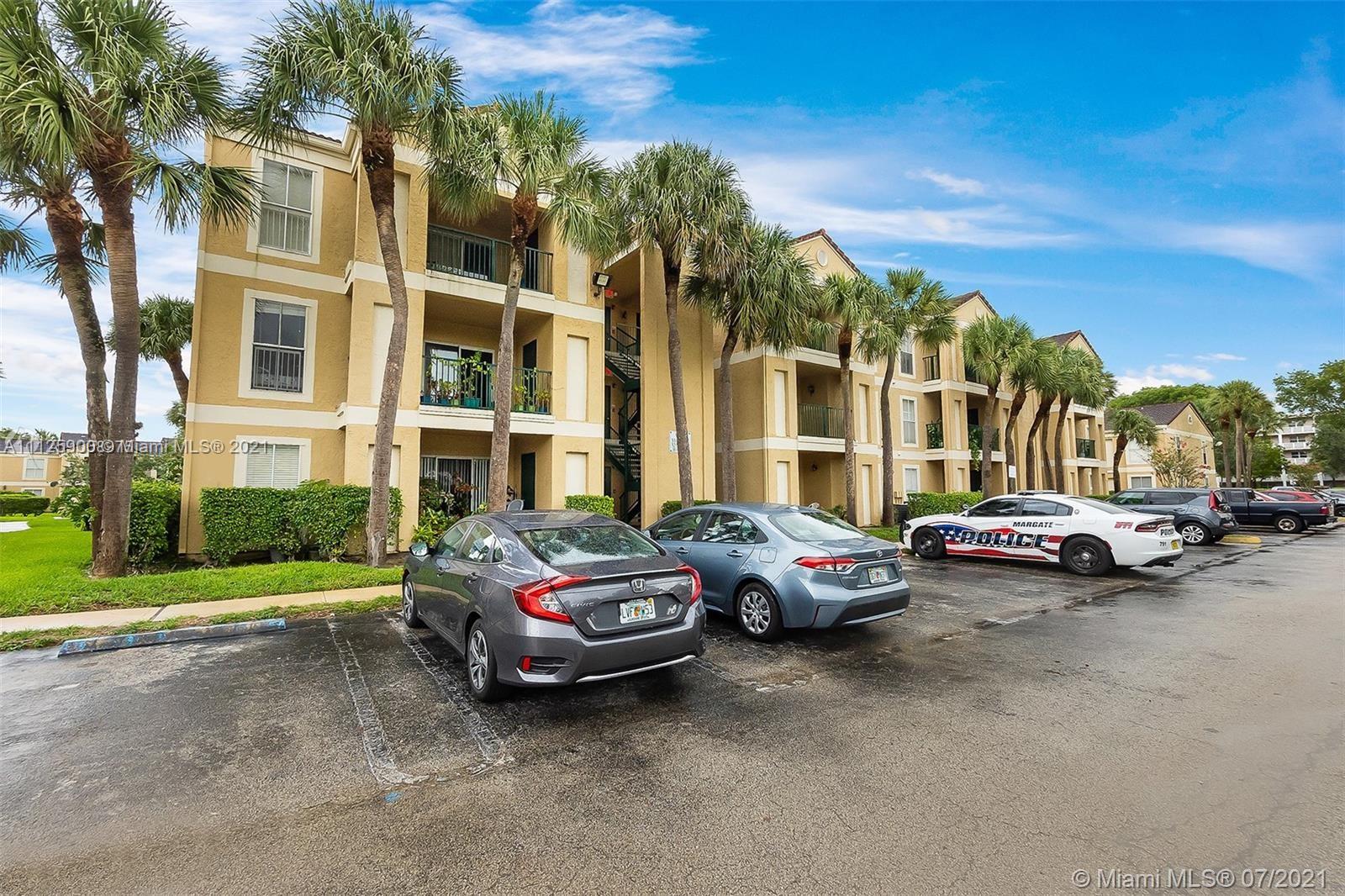 833 Riverside Drive, Unit 817 Coral Springs, FL 33071 - Photo 2 of 10 a cars parked in front of a building