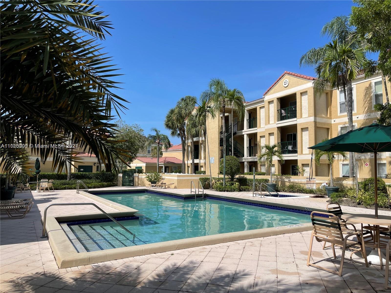 833 Riverside Drive, Unit 817 Coral Springs, FL 33071 - Photo 5 of 10 a view of a patio with couches table and chairs and potted plants