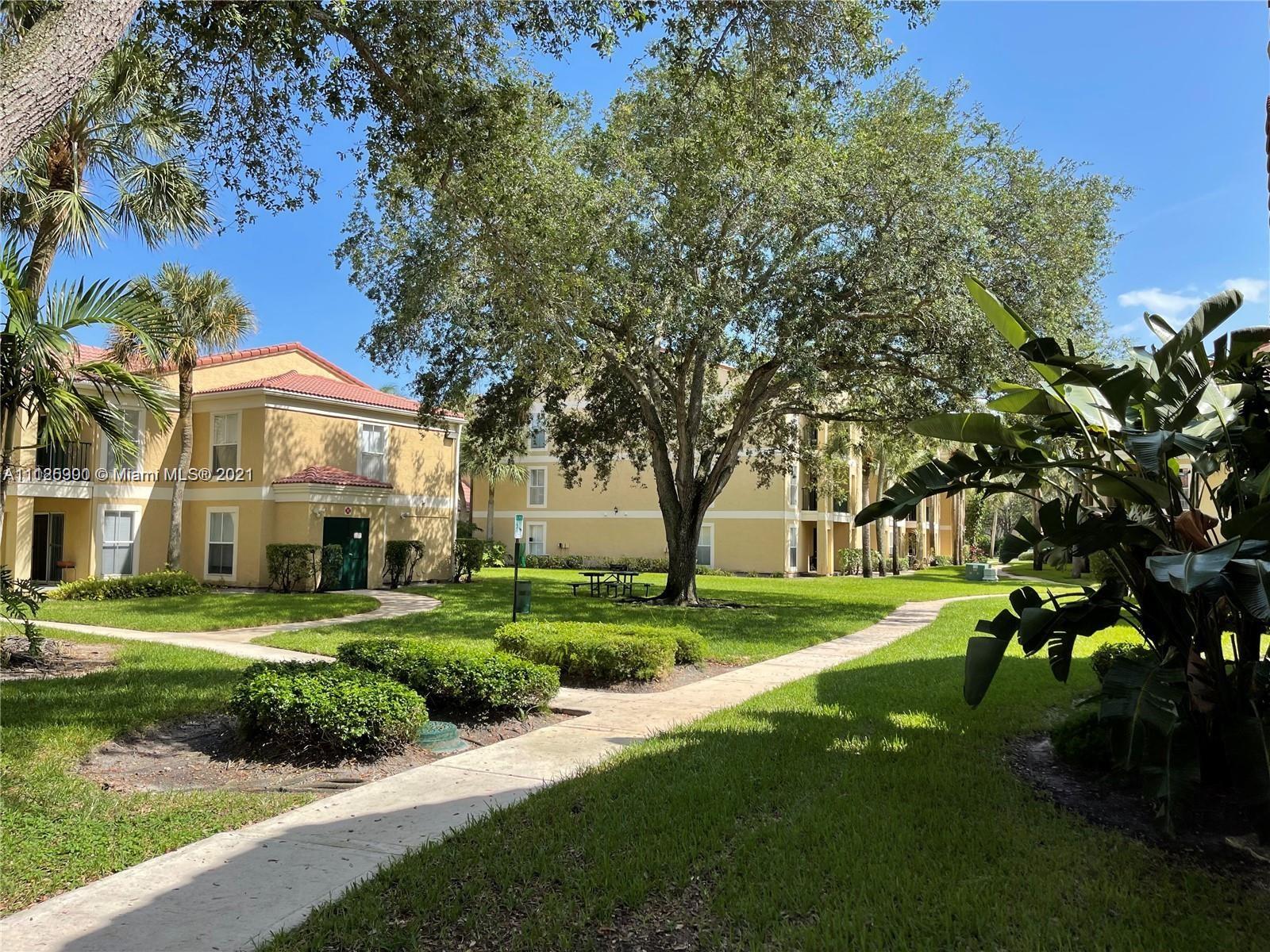 833 Riverside Drive, Unit 817 Coral Springs, FL 33071 - Photo 6 of 10 a front view of a house with a yard
