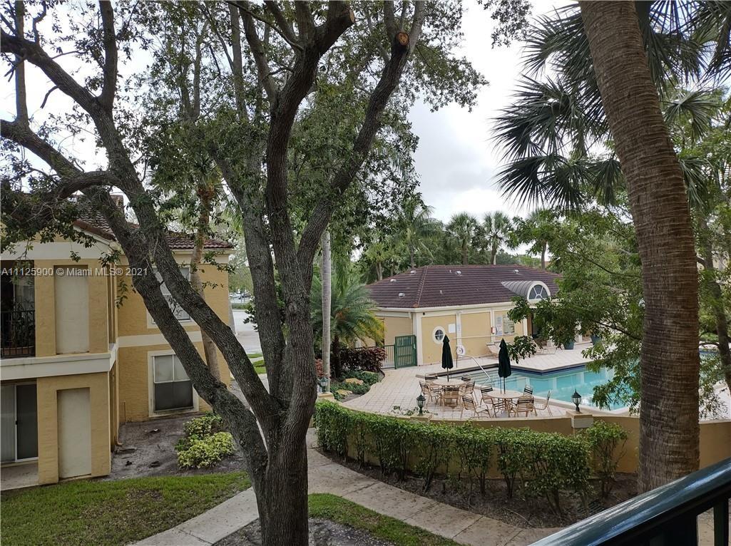 833 Riverside Drive, Unit 817 Coral Springs, FL 33071 - Photo 7 of 10 a front view of a house with a yard