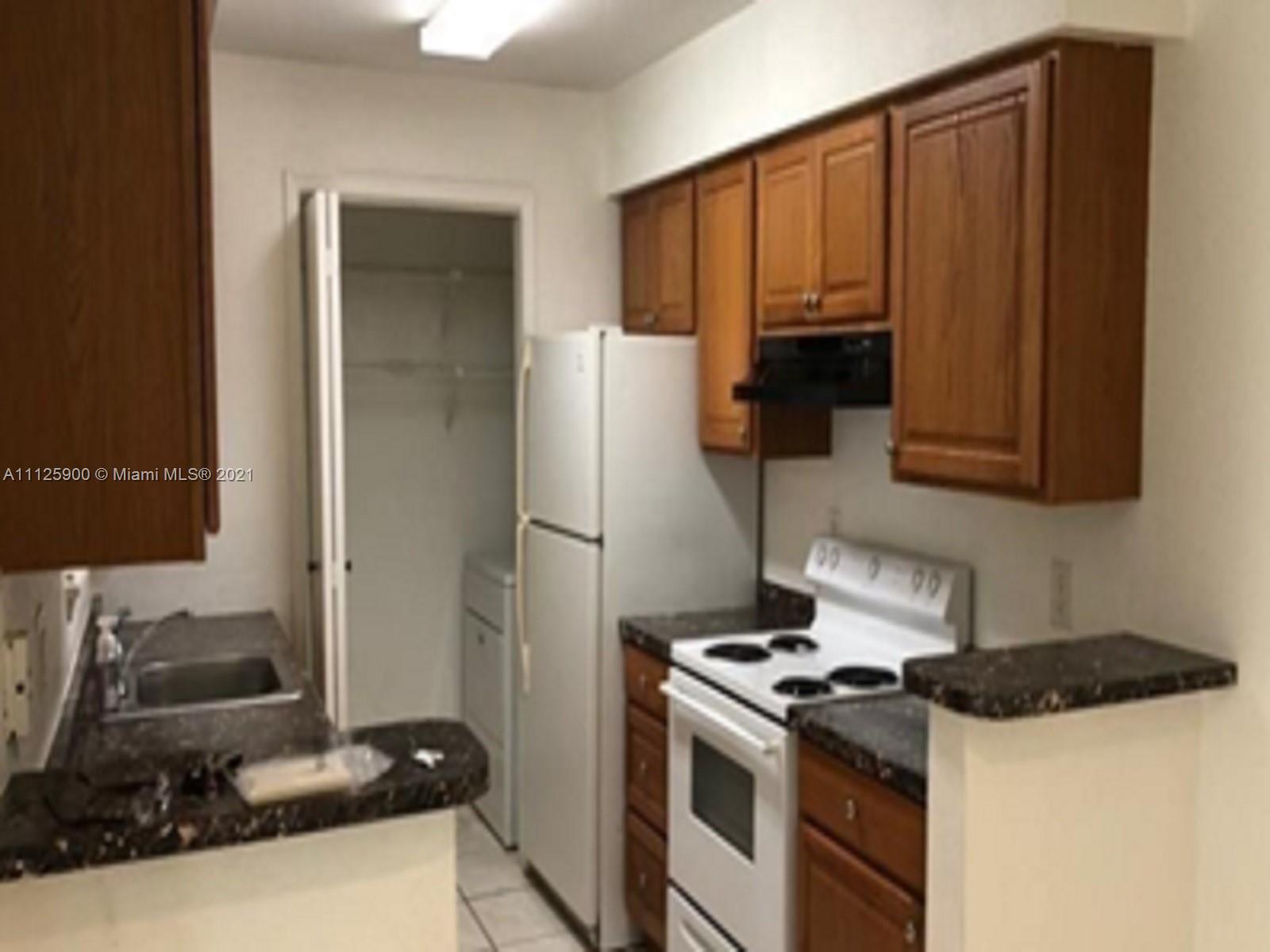 833 Riverside Drive, Unit 817 Coral Springs, FL 33071 - Photo 8 of 10 a kitchen with a stove and a refrigerator