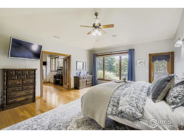 a bed room with a bed and a television