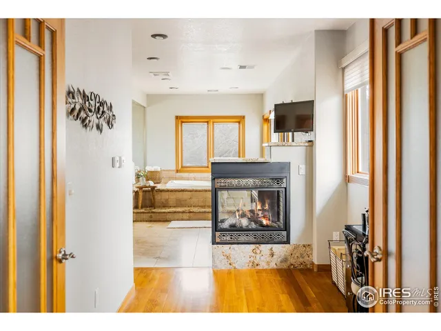 a living room with a fireplace and a flat screen tv