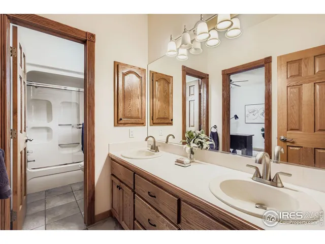 a bathroom with a double vanity sink and a mirror