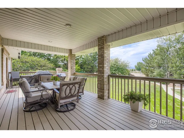 a view of balcony with chairs and wooden floor