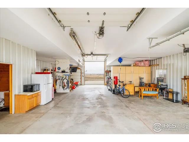a storage room with lots of white furniture