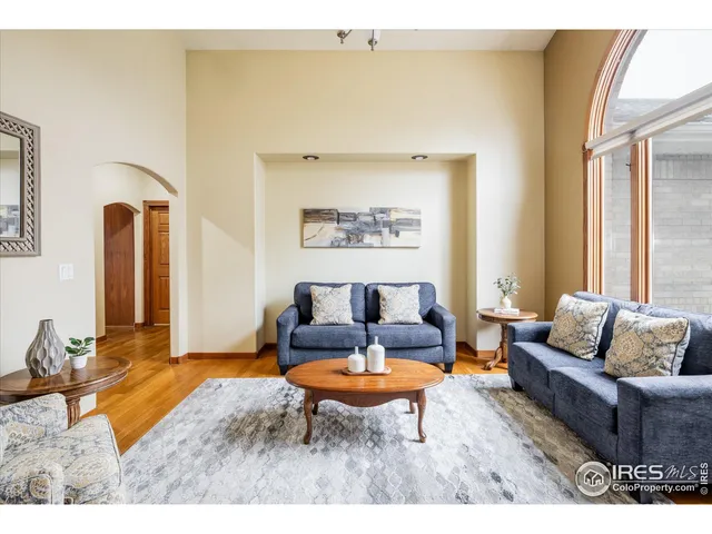 a living room with furniture a rug and a table