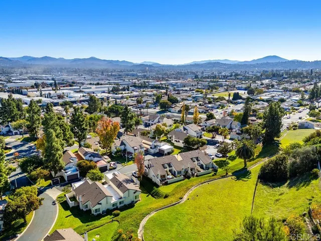 an aerial view of residential houses with outdoor space