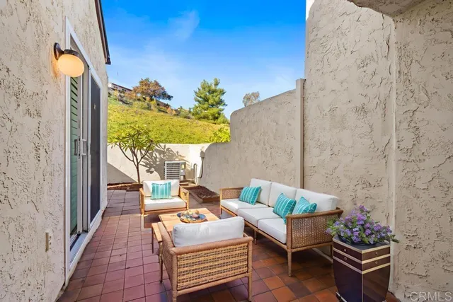 a outdoor living room with furniture and a potted plant