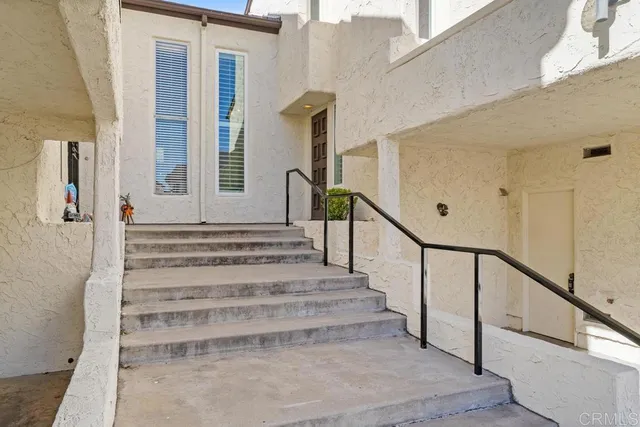 a view of entryway with wooden floor and stairs