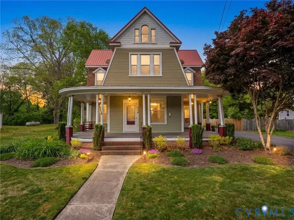 a front view of a house with yard and green space