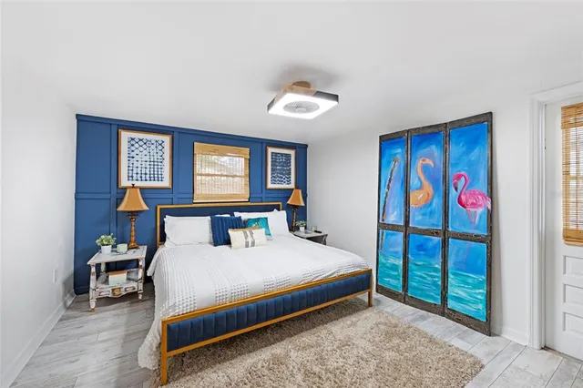 a bedroom with furniture and flat screen tv