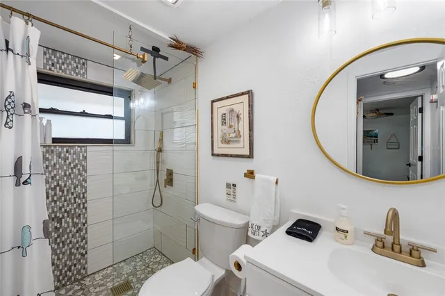 a bedroom with a bed a mirror and a shower