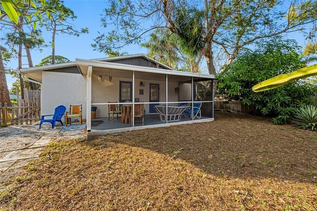 a view of a yard with wooden fence