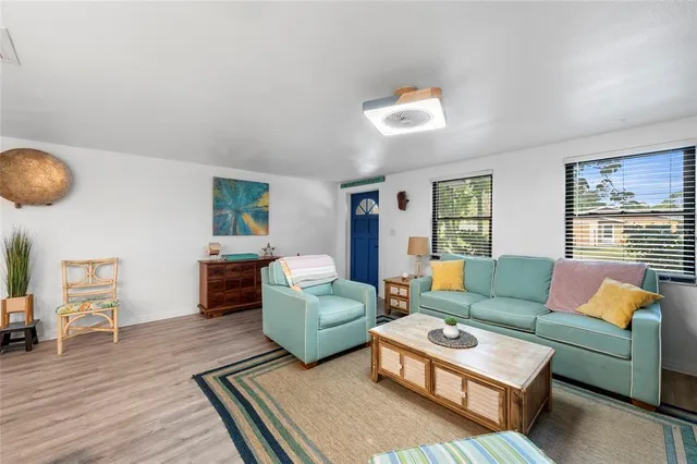 a living room with furniture and kitchen view